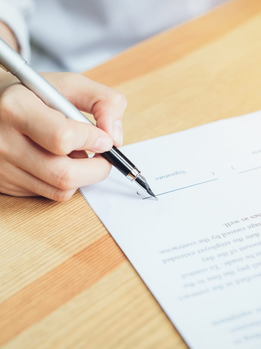 closeup of signing a documentation agreement and pen on the table.