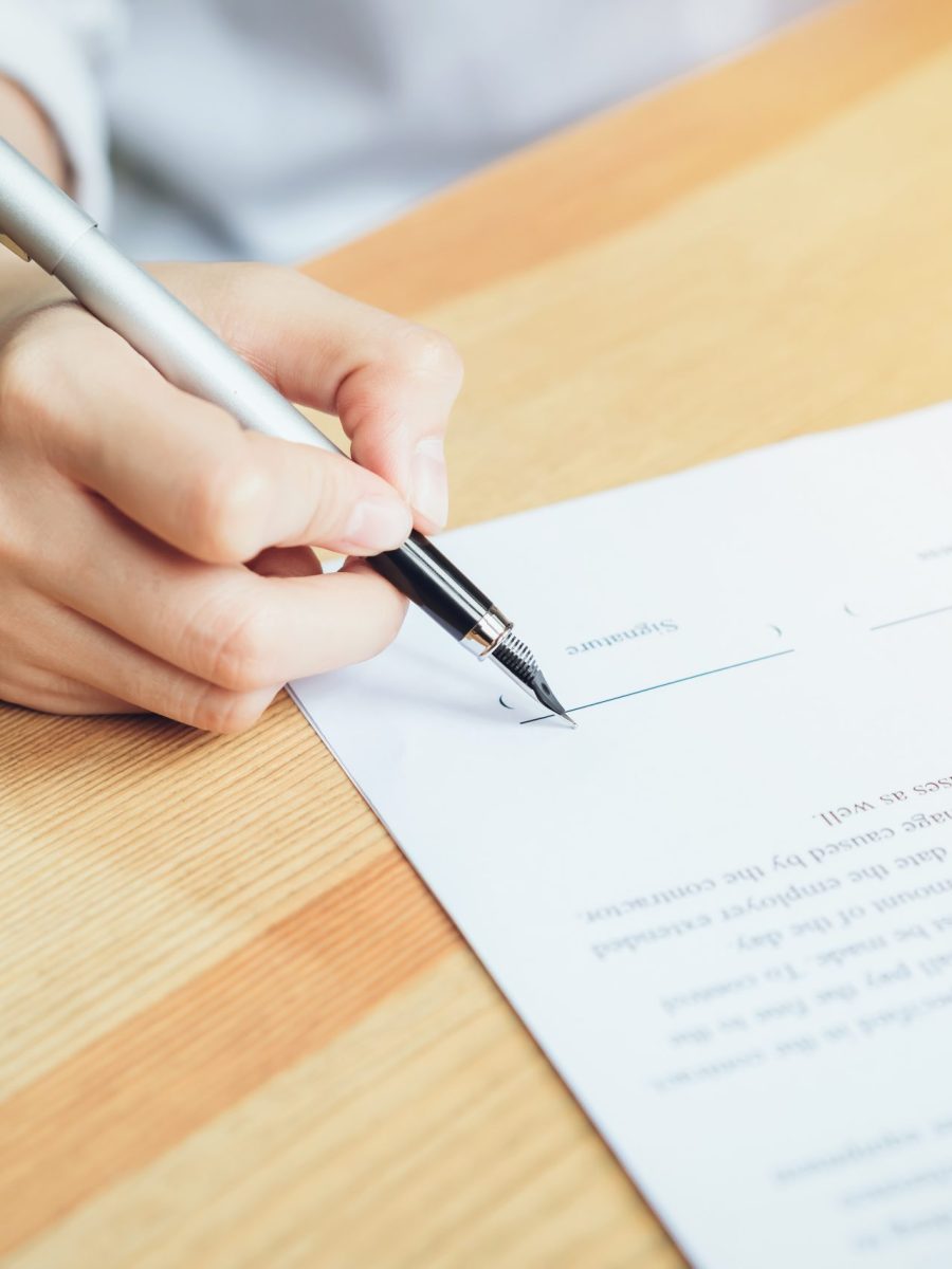 closeup of signing a documentation agreement and pen on the table.