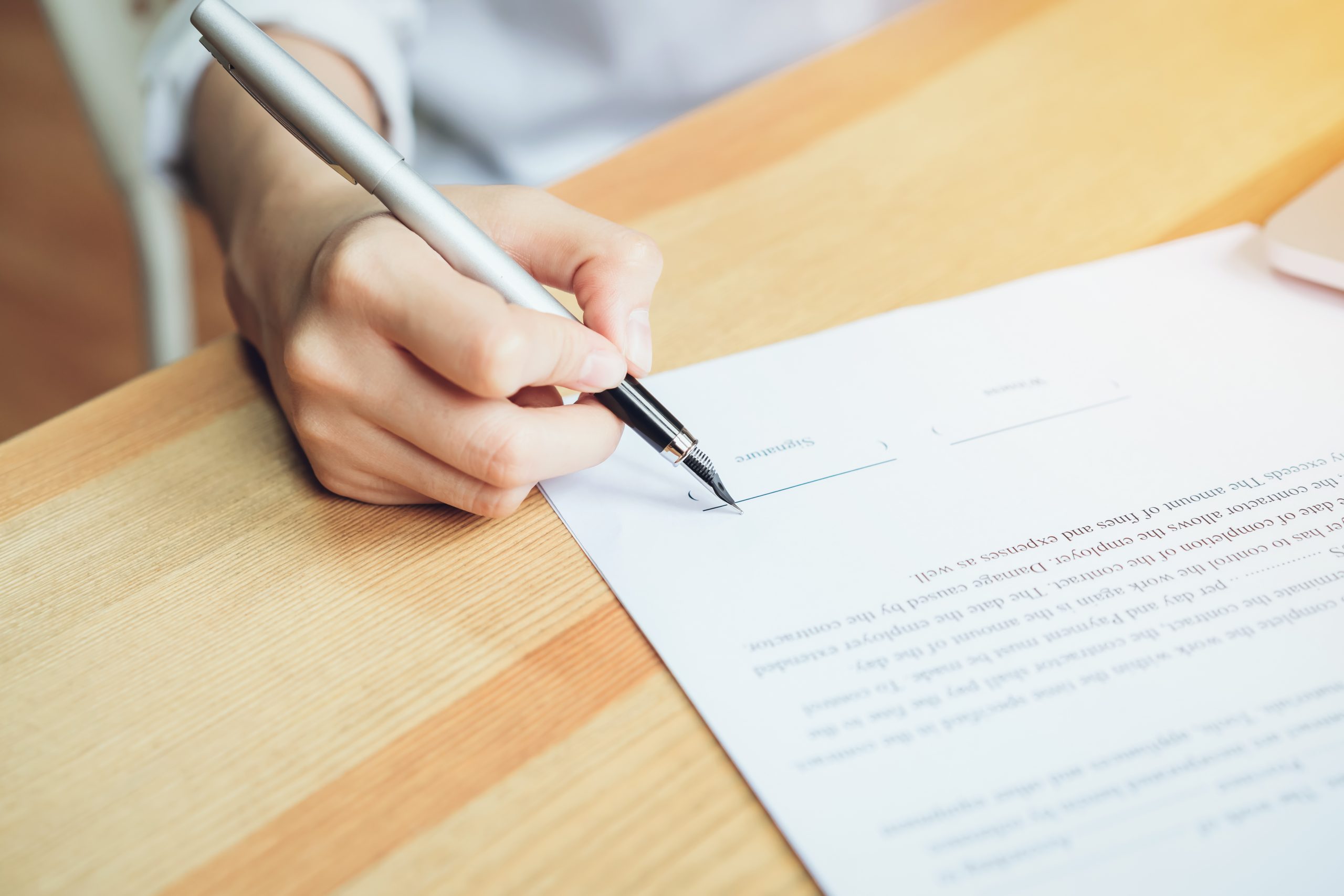 closeup of signing a documentation agreement and pen on the table.